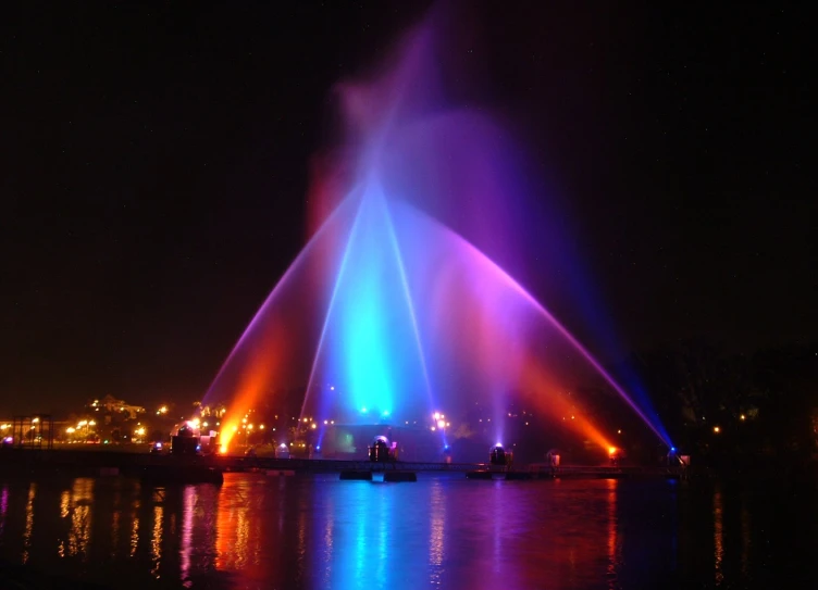 several lights shining on the water and reflecting on the surface