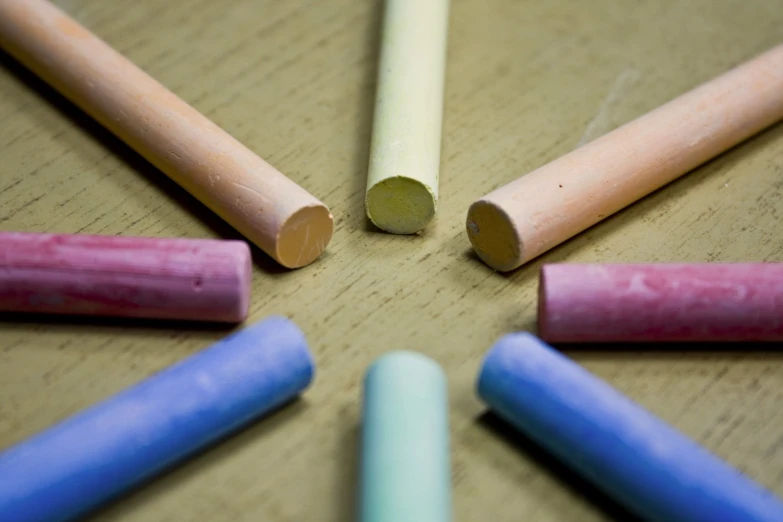 a group of pencils lie on a wooden table