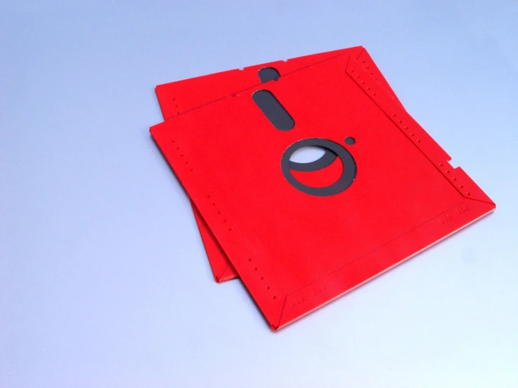 a small red paper bag with a black rubber design