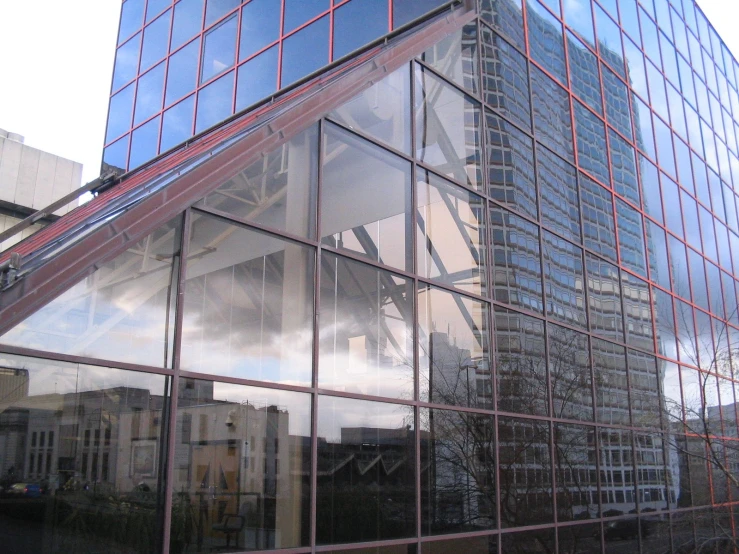 a building is reflected in a glass structure