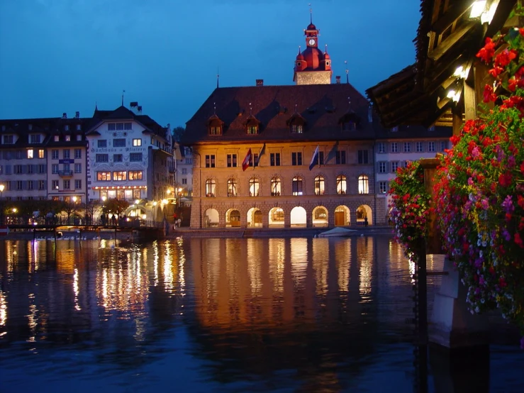 a nighttime view of a european city with a lake