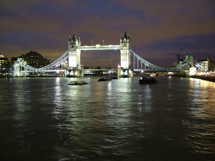 there is a city at night and the bridge looks like soing from the other side