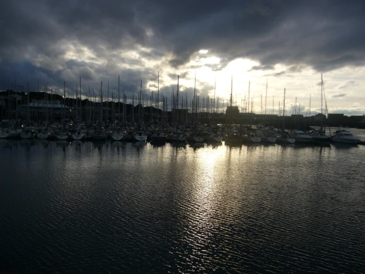 a small harbor with sail boats in the background