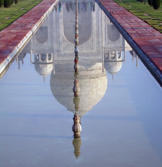 a reflection of the taj mulgoor in water