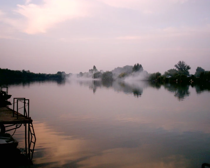 misty morning fog on the water with boats in it