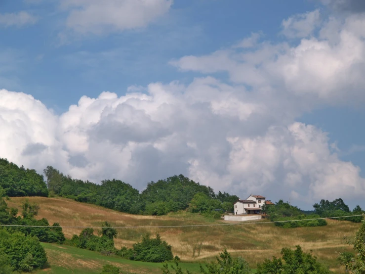 an empty house sits in the middle of a large field