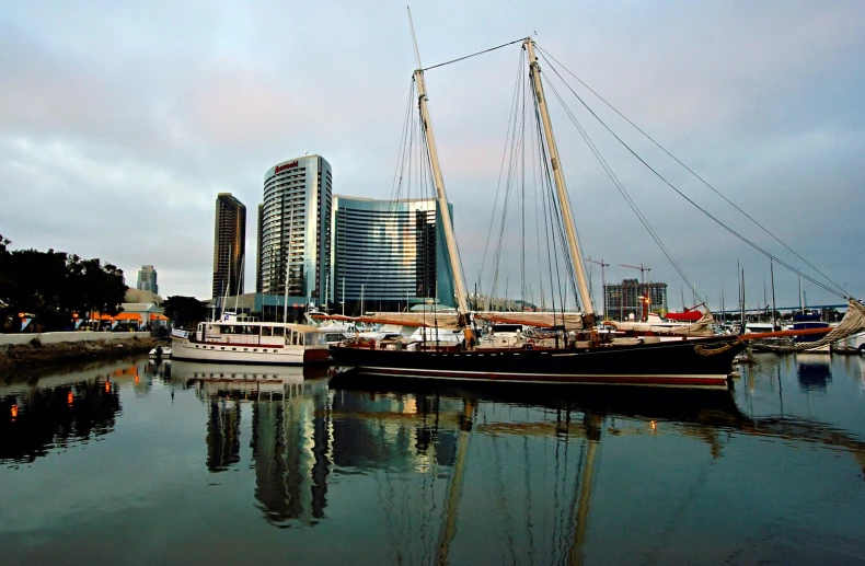 some boats on a body of water near large buildings