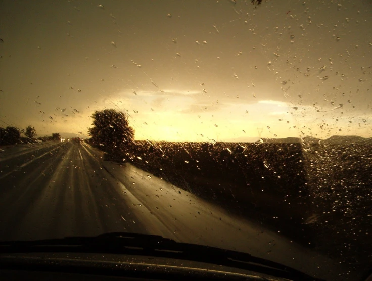 the sun shines brightly through the windshield of an over head vehicle