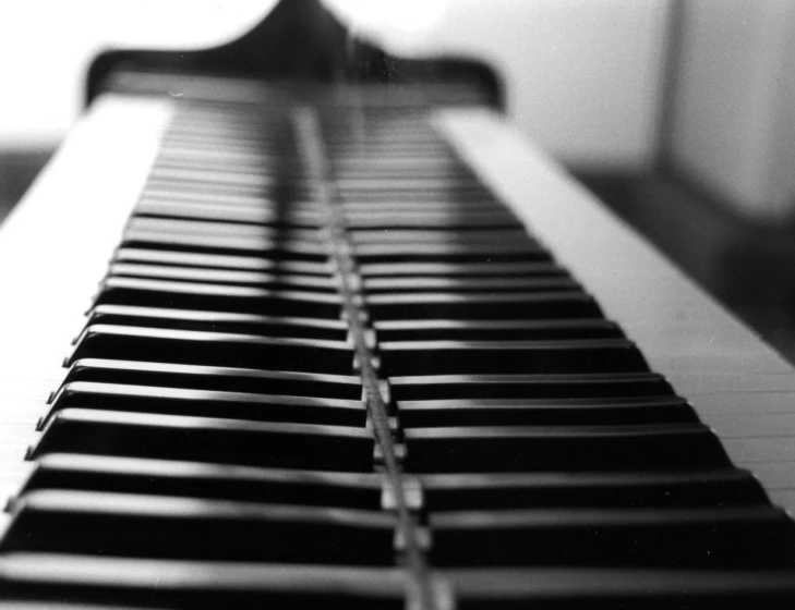 a large piano sits in a black and white po