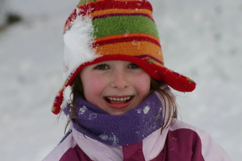  in snow hat and scarf smiling