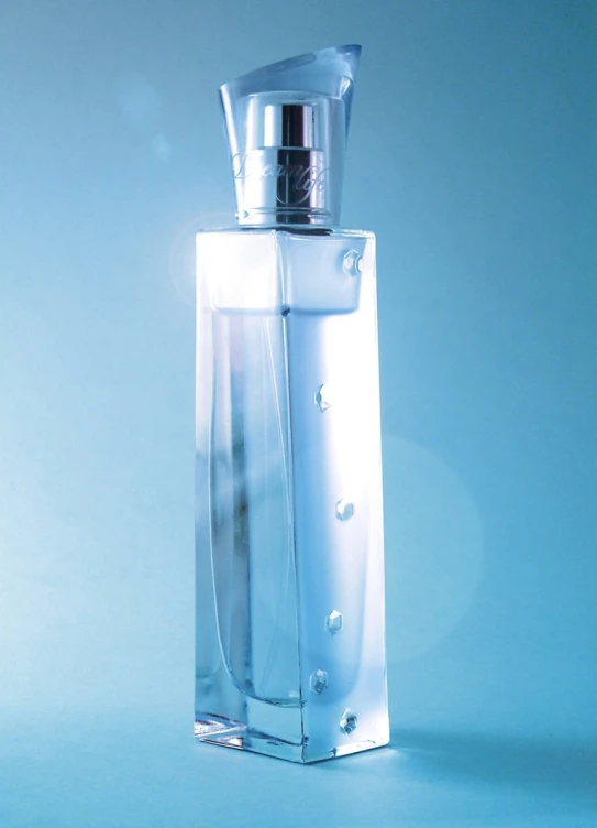 an empty bottle in clear glass on a light blue background