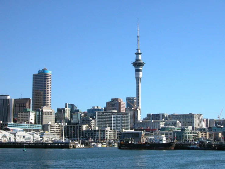 a large body of water next to a tall city