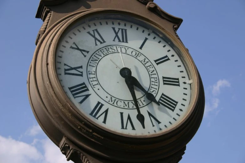 a clock tower with roman numerals on a sunny day