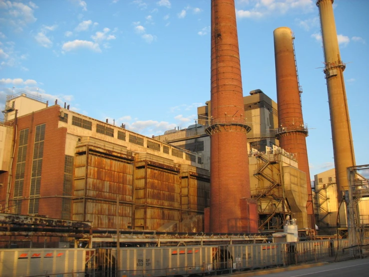 a large industrial plant with a train passing by