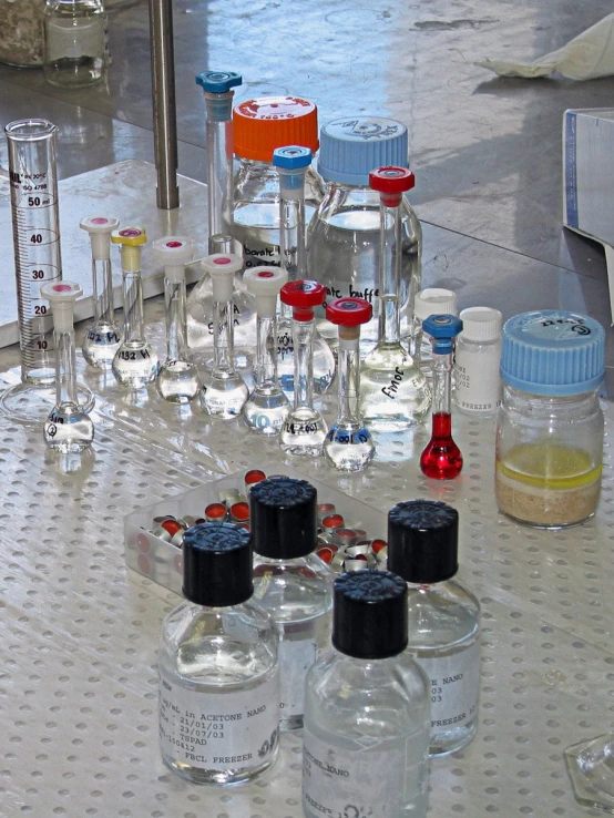 several bottles and glasses sit on a table