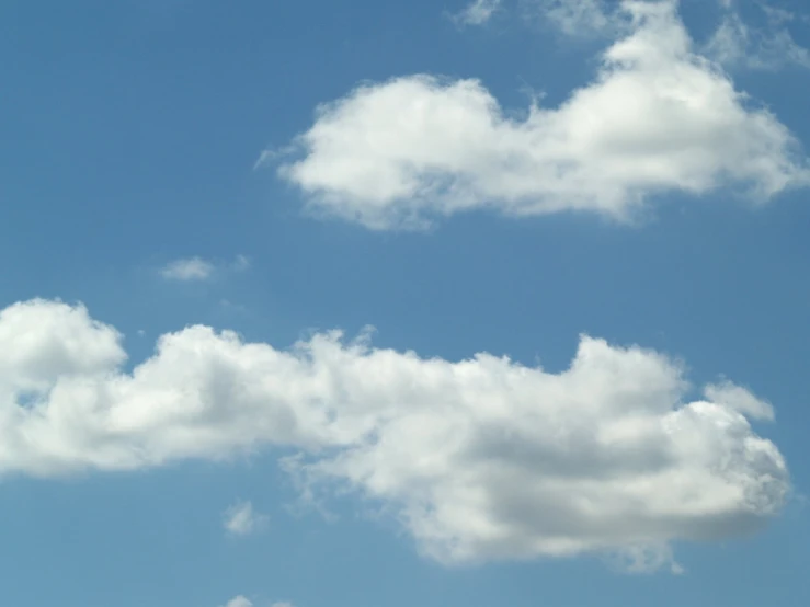 three planes fly high in the sky over a city