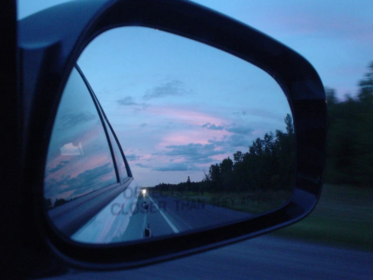 a rear view mirror reflecting the sun down