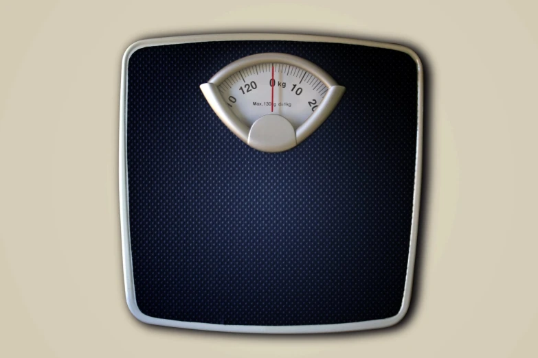 a bathroom scale with a white dial on the front