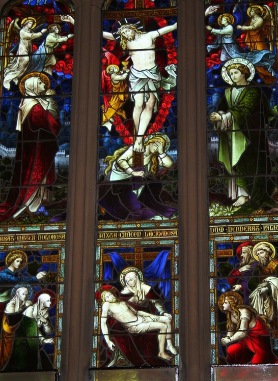 the four main stained glass window shows jesus being nailed by christ's body