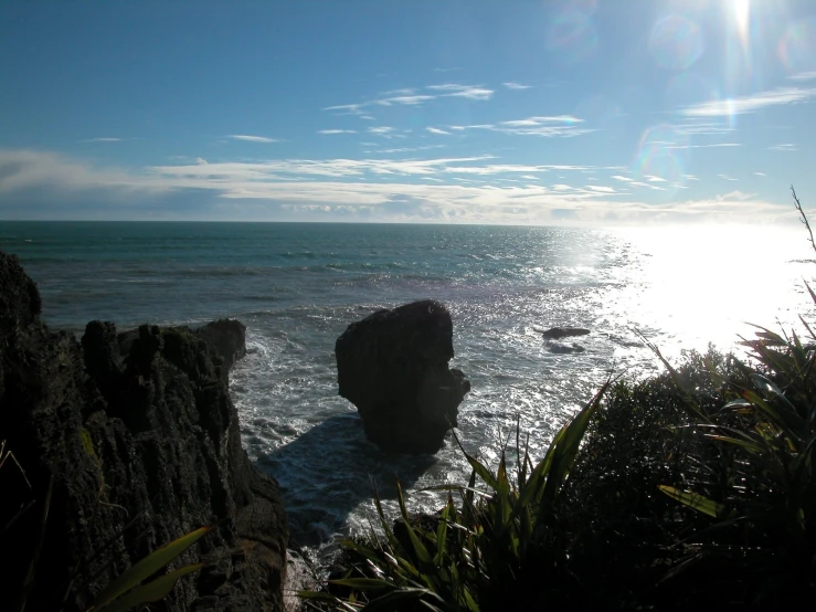 two rocks sitting at the end of a cliff