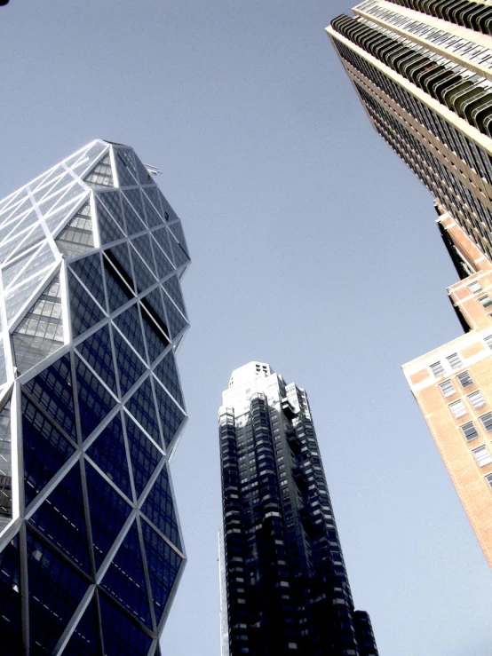 several high rise buildings against a blue sky