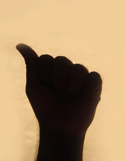 a person reaching out their left hand towards the sky