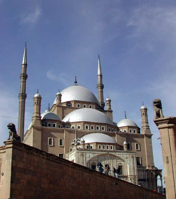 a large dome building sits above two small towers