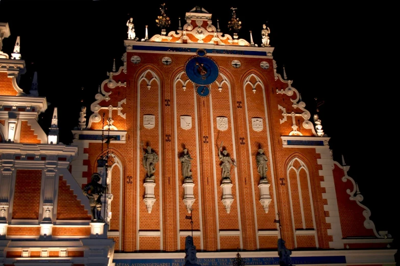 an ornate building is lit up with a blue clock