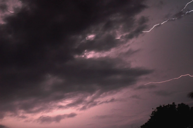 a cloudy sky that has some lightning bolts