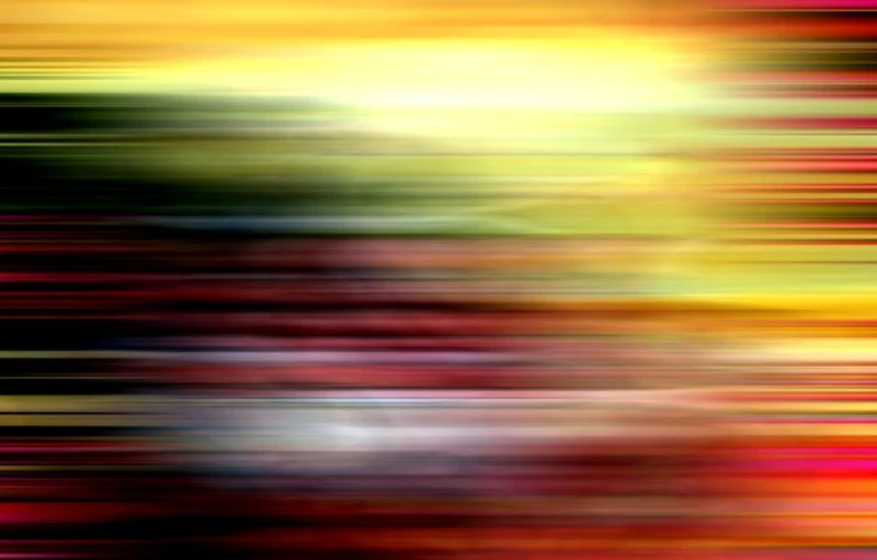 a very blurry and artistic image of an orange, red, yellow and black striped background