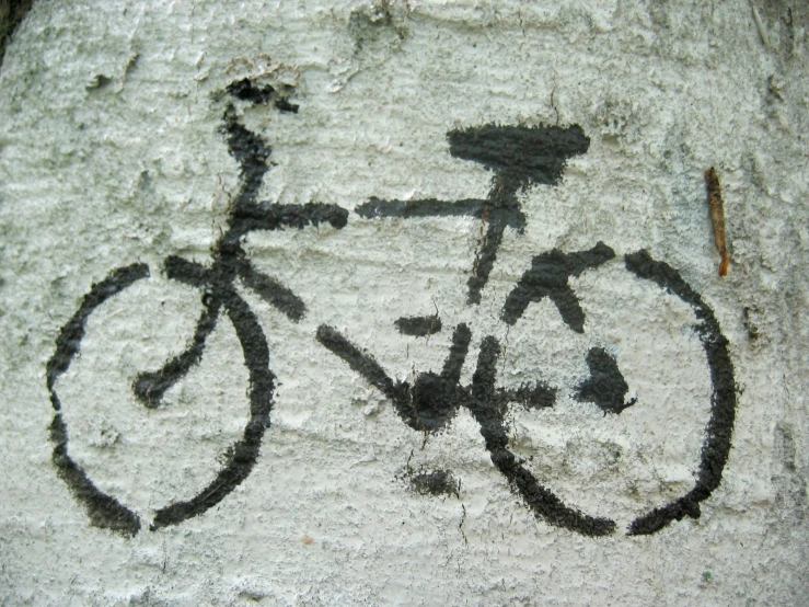a bike is drawn on the side of a rock