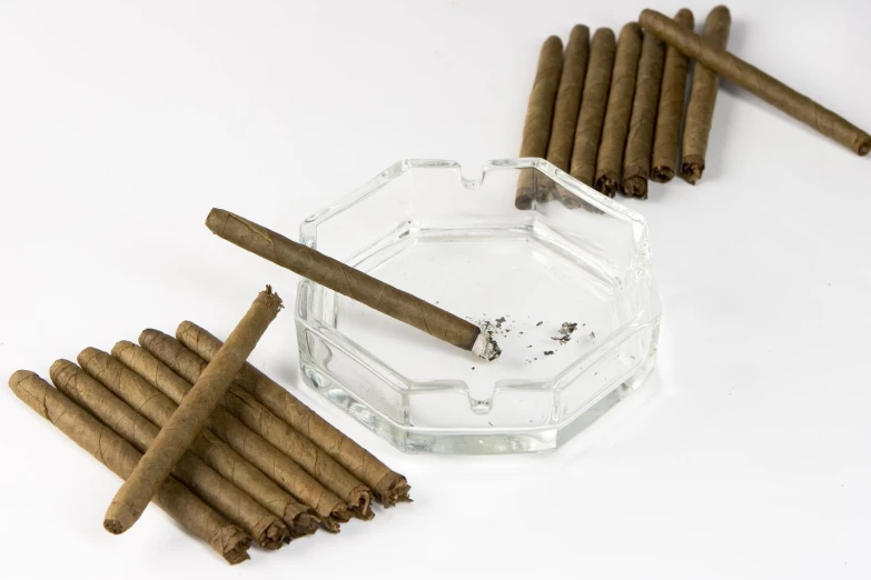 four cigars, one of which has been rolled up, and two are placed in a honey comb pattern