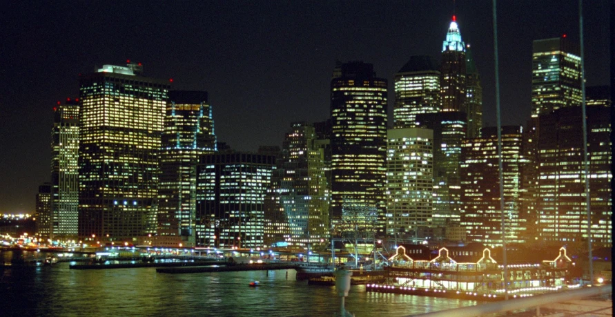 an urban city skyline at night seen from a large body of water