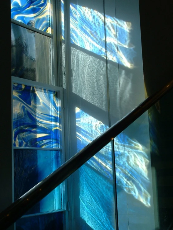 glass blocks are arranged to reflect light and shadows