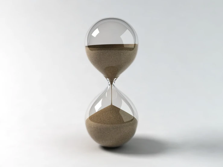 a sand - filled glass vase on white background