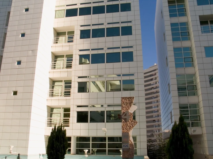 two tall white buildings in a city park