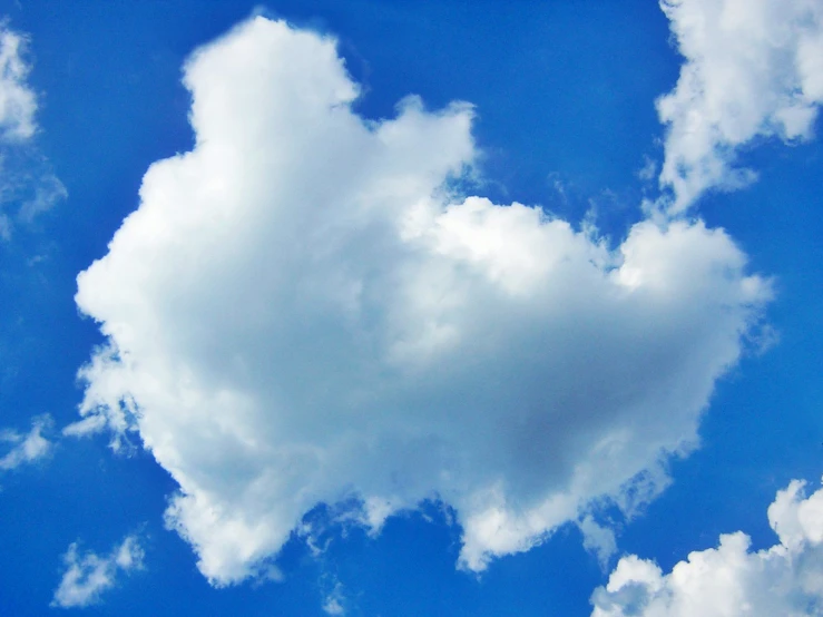 a white heart shaped cloud in the sky