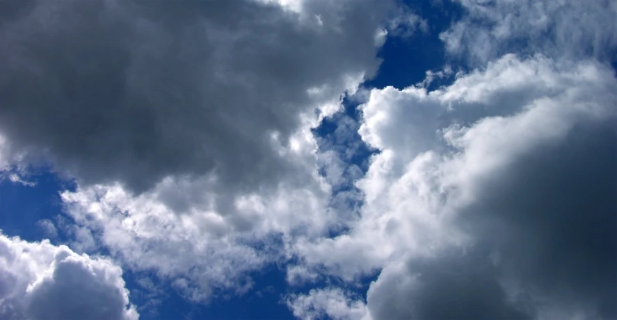 a very cloudy sky with the sun shining through