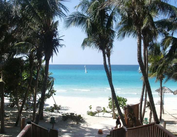 the view of some beautiful beach with people walking