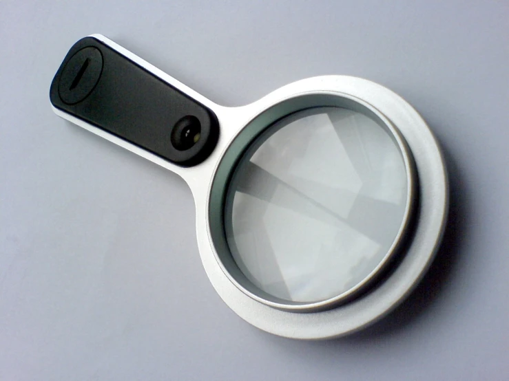 there is a magnifying glass with a black on on it