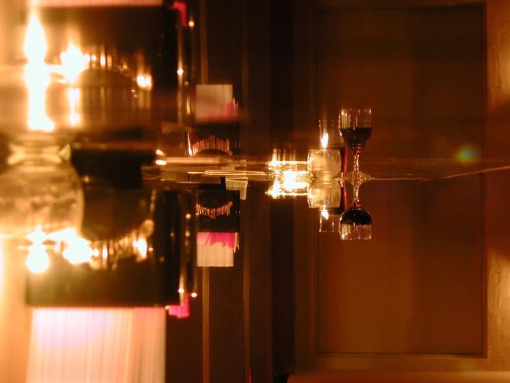 two bottles of wine are shown in the reflection of a mirror