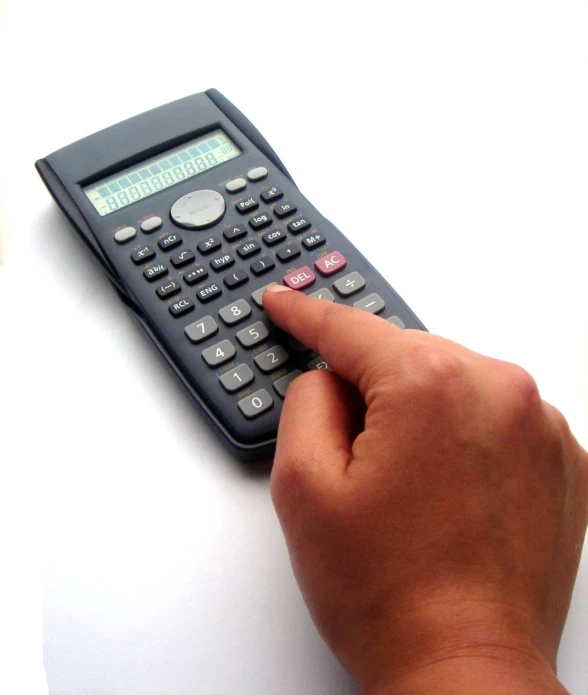 a hand with a calculator is pressing a on