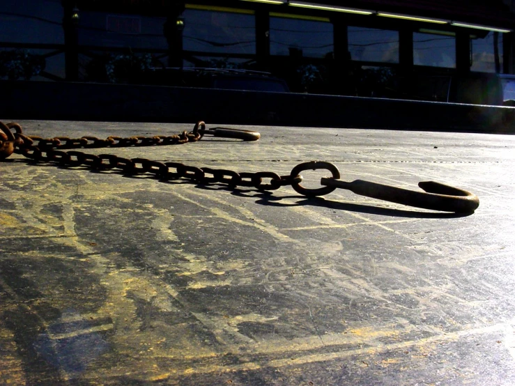 a bike chain laying on a paved surface