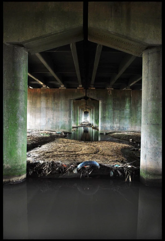 a couple of long concrete pillars inside of a building