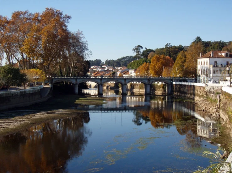 this is a bridge that crosses the river near an old town