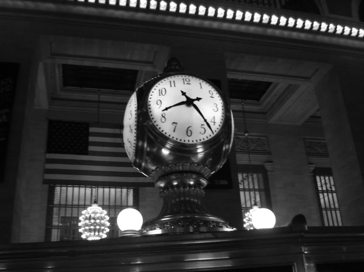 a clock mounted on the side of a pillar