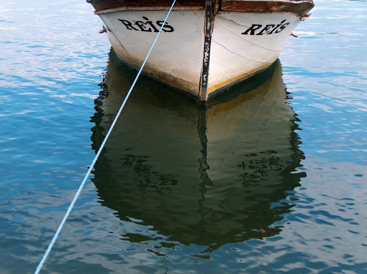 a white and red boat in water on land