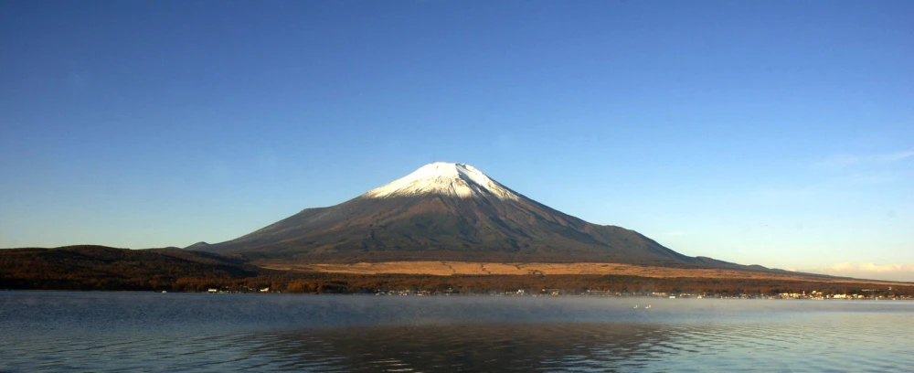 an empty body of water with a mountain behind it