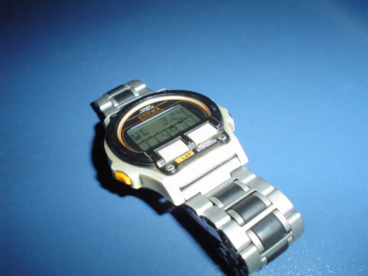 a watch is shown on a table with blue countertop