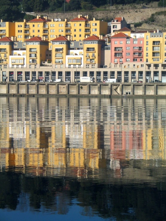 the reflection of a colorful city with many tall buildings in it